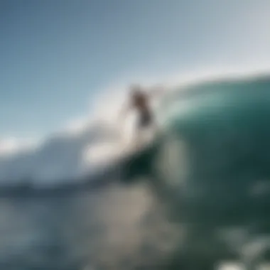 A person practicing wakesurfing behind a boat in clear waters