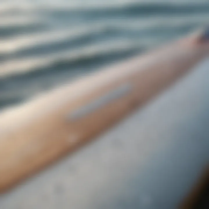 A close-up of a surfboard with visible damage ready for repair