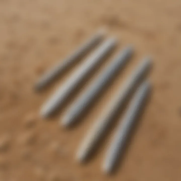 An array of eco-friendly surf zinc sticks displayed on a sandy beach