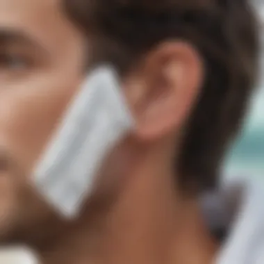 A close-up of a towel being used to dry the outer ear, emphasizing a safe method