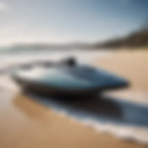 A close-up of an electric jet-powered body board on a sandy beach.