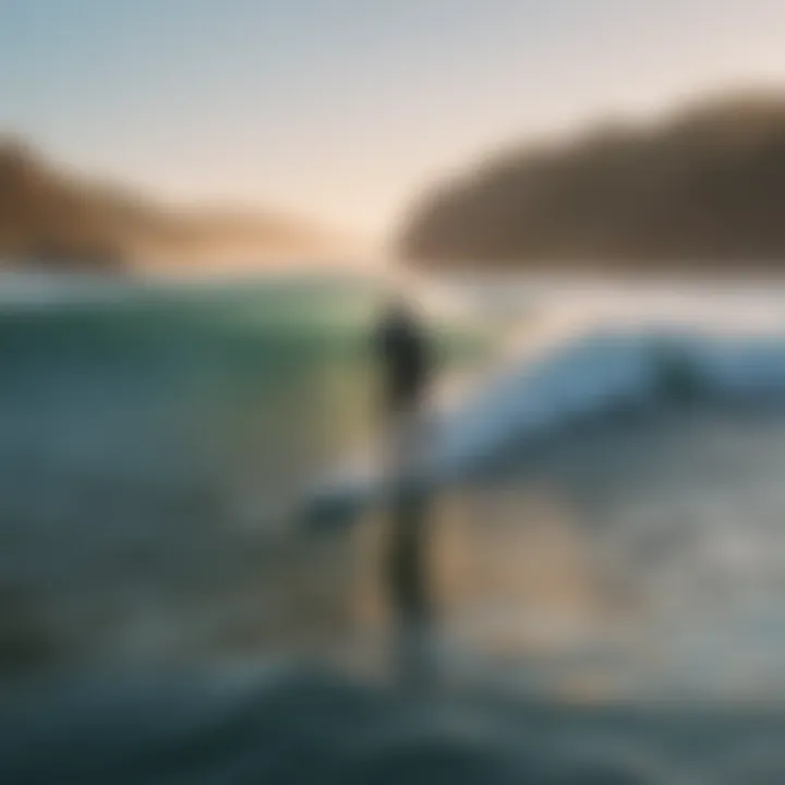 A tranquil morning surf session with a lone surfer on calm waters