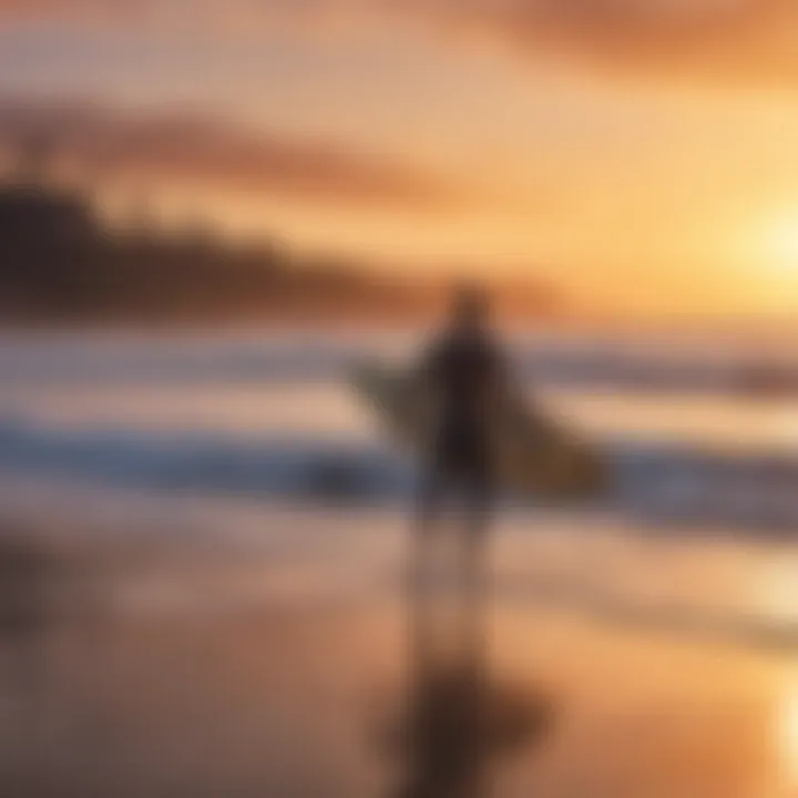 Surfer carrying a surfboard on a beach at sunset.