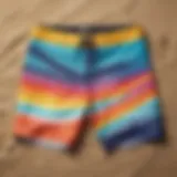 Vibrant surf board shorts displayed on a sandy beach