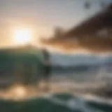 A surfer catching a wave at Pacific Beach during sunset