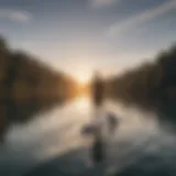 A serene view of paddle boarding on a calm lake at sunset