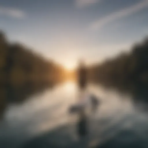 A serene view of paddle boarding on a calm lake at sunset