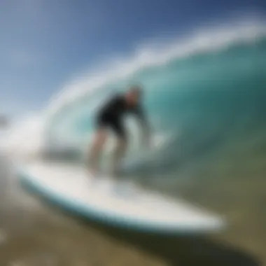 Surfer applying Bilt Hamber Surfex HD on a surfboard