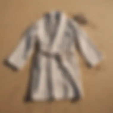 Eco-Friendly Towelling Robes on the Sand A selection of eco-friendly towelling robes displayed on a sandy beach