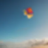 A vibrant kite soaring high against a clear blue sky