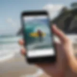 A surfer checking tide alert app on a smartphone by the beach