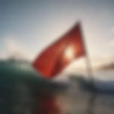 A close-up view of a red flag fluttering in the breeze at a surf beach.