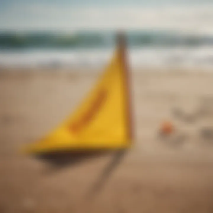 A vivid yellow flag displayed prominently on the sandy beach next to the surf.