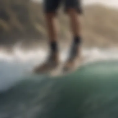 Surfer wearing Vans booties while riding a wave